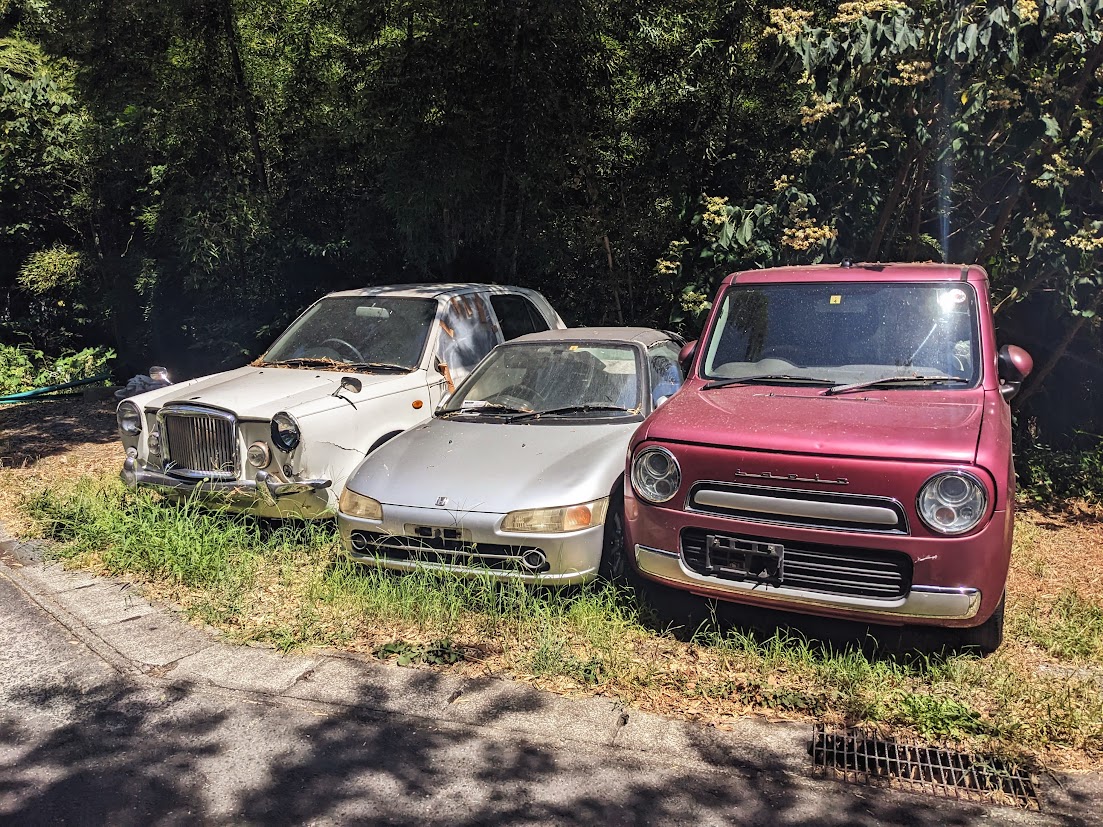 Three abandoned cars